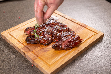 Food and horse meat concept - Roast meat on cutting board with cumin