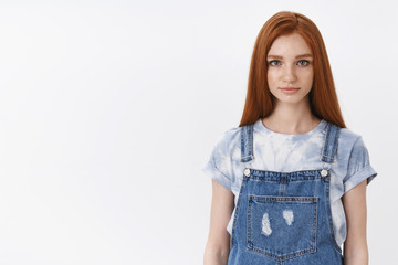 Obraz premium Serious-looking redhead teenage girl with blue eyes look sincere hopeful, have important conversation, something interesting tell you, have pleasant talk, stand white background denim overalls