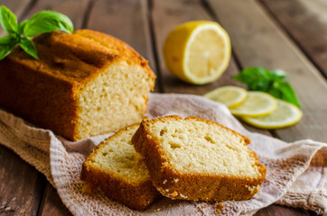 Lemon pound cake on rustic wooden background with lemon