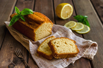 Lemon pound cake on rustic wooden background with lemon