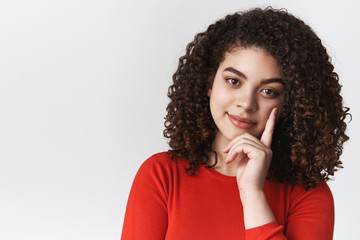 Fototapeta na wymiar Close-up stylish confident good-looking tender young mixed-race woman dark curly hairstyle lean head index finger smirking delighted curious look thoughtful camera have interest conversation