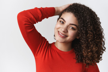 Close-up romantic tender flirty young sensual woman dark curly hairstyle touching haircut grinning camera seducing posing coquettish grinning chuckling cute standing white background