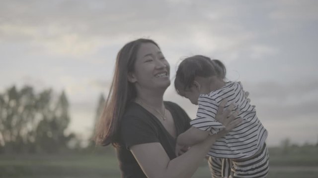 Asian moms and daughters are playing in the outdoor fun at sunset. happily, Slog3