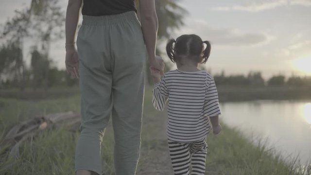 Asian moms and daughters are happily walking and enjoying outdoors. Slog3