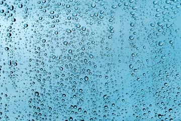 Fototapeta na wymiar Water drops on glass, green texture