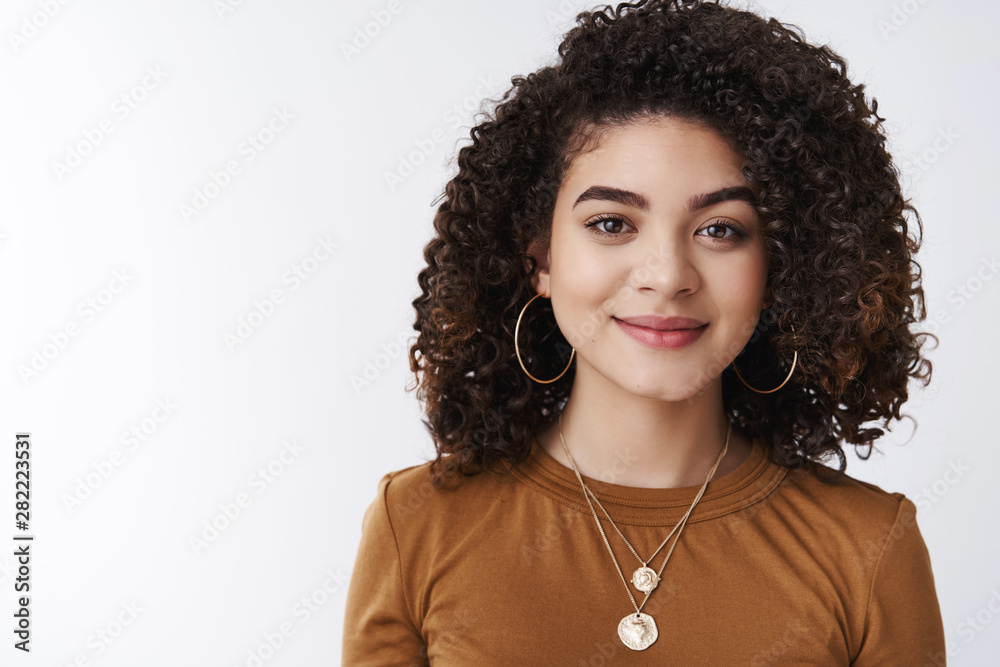 Wall mural Stylish good-looking happy carefree dark curly-haired girl smiling delighted wear trendy necklace grinning tender gladly listen conversation attend company meeting look pleasant, white background