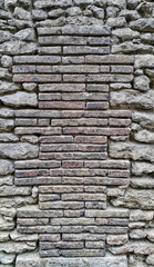 Ancient wall with bricks and cobblestones