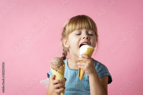 Little Girl With Pigtails In A Blue Dress Eating Ice Cream In A Cone On A Pink Background Wall Mural Olgamazina