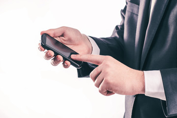 successful businessman clicks on the smartphone screen.