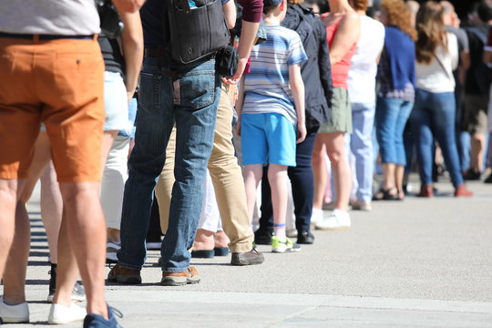 Long Queue Of People Waiting In Line