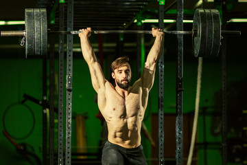 Handsome men doing exercises with barbells. Weightlifting.