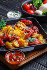 Potato baked with sausages along with sauce