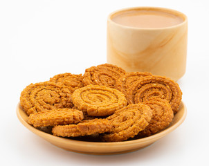 Indian Traditional Tea Time Snack Chakli, a spiral shaped crisp deep fried snack, It is known as  Chakali, Murukku, Muruku, Murkoo, Chakri in Gujarat, Chakli in Maharashtra and Northern India