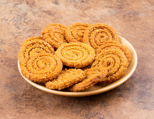 Indian Traditional Snack Chakli, a spiral shaped crisp deep fried snack, It is known as  Chakali, Murukku, Muruku, Murkoo, Chakri in Gujarat, Chakli in Maharashtra and Northern India