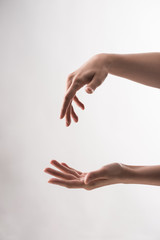 cropped view of woman with gesturing hands on white background