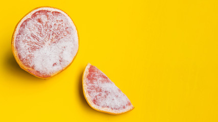 Frozen grapefruit on yellow background