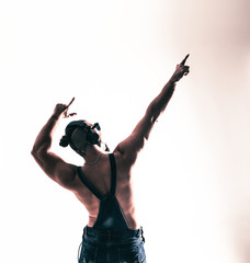 rear view - the rapper shirtless with headphones and stylish hai