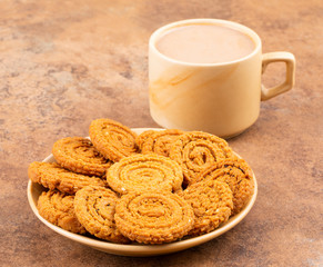 Indian Traditional Tea Time Snack Chakli, a spiral shaped crisp deep fried snack, It is known as  Chakali, Murukku, Muruku, Murkoo, Chakri in Gujarat, Chakli in Maharashtra and Northern India