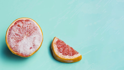 Frozen grapefruit on turquoise background