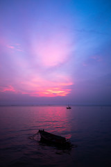 local fishing boat in the sea at sunset