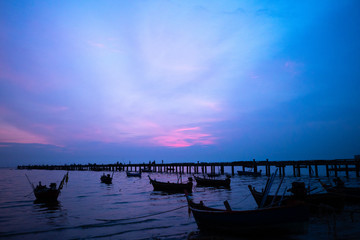 Fototapeta na wymiar Fishing boat on the sea, .Fishing village at sunset