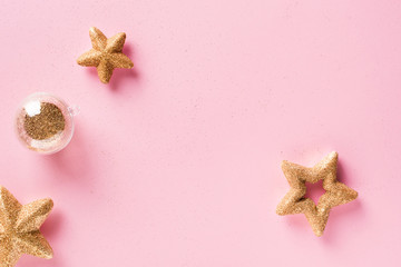 Christmas and holiday pink  background with golden stars
