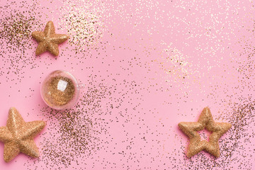 Christmas and holiday pink  background with golden stars