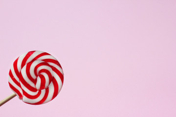 Lolli pop candy in left corner of pink background