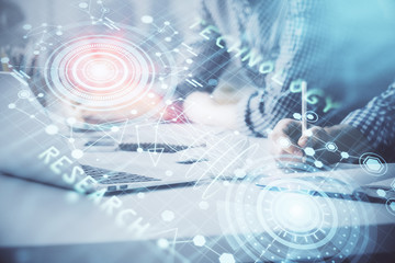 Businessman with computer background with technology theme hologram. Concept of hightech. Multi exposure.