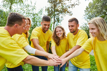 Young people in the start-up team are stacking hands
