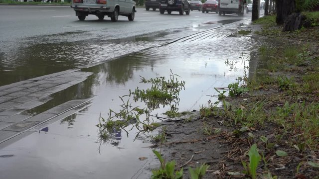 Wave of spray from under the wheels of a truck. Water on the road. Spray from under the wheels of cars.