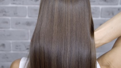 Result after lamination and hair straightening in a beauty salon for a girl with brown hair. hair...