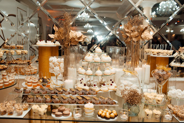 Candy Bar. Delicious sweet buffet with cupcakes. Sweet holiday buffet with cupcake. Wedding, the design and decoration Candy bar table .