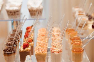 Delicious sweets on wedding candy buffet with desserts, cupcakes