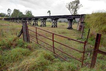 rail bridge with a rusty gate in the forground