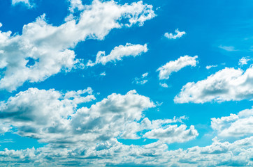 Naklejka na ściany i meble Beautiful blue sky and white cumulus clouds abstract background. Cloudscape background. Blue sky and fluffy white clouds on sunny day. Nature weather. Bright day sky for happy day background.