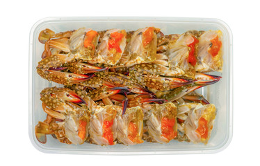 Pickled crab eggs in fish sauce pack in plastic box for delivery. Seafood delivery business. Exotic menu in Thailand. Pickled crab eggs in disposable plastic container isolated. Sea food industry.