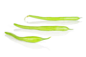 Group of three whole fresh green bean placed diagonally in line isolated on white background