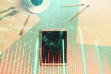 Double exposure of forex graph on digital tablet laying on table background. Concept of market analysis