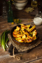 Delicious baked potatoes on wooden table. Rustic stale. closeup