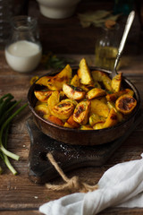 Delicious baked potatoes on wooden table. Rustic stale. closeup