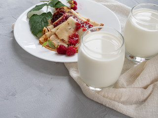 Homemade pancakes with raspberry jam, natural milk. Copy space.