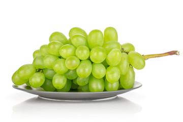 Lot of whole fresh green grape on gray ceramic plate isolated on white background
