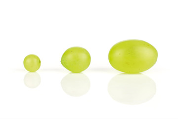 Group of three whole fresh green grape in row isolated on white background