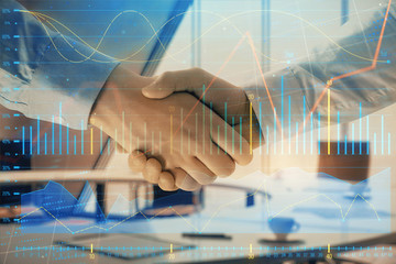 Multi exposure of financial graph on office background with two businessmen handshake. Concept of success in business