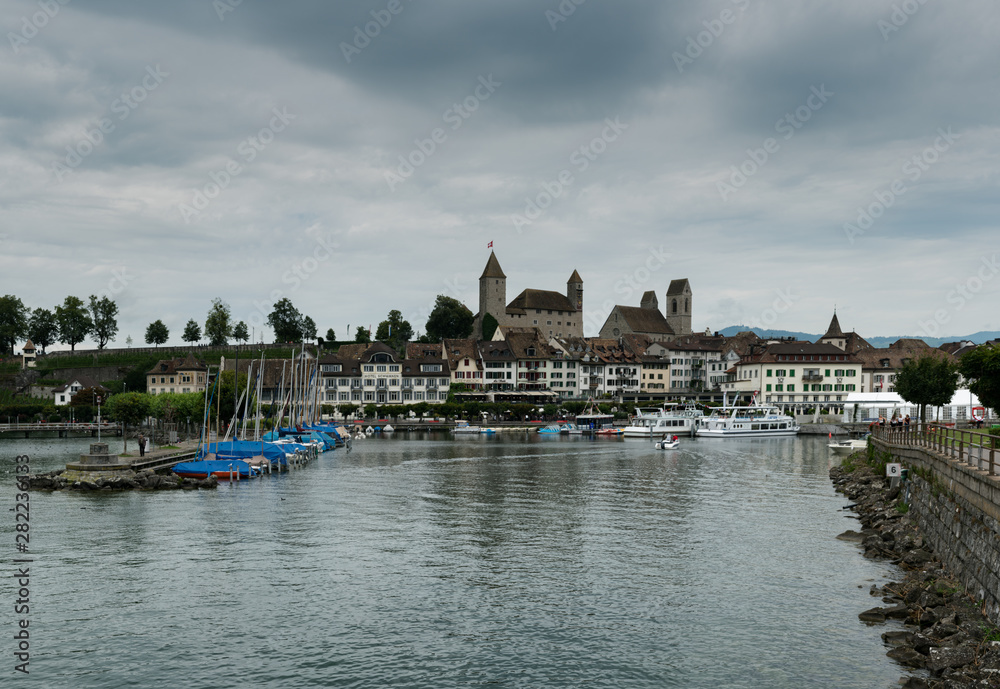 Poster harbor and city of rapperswil with the historic castle and church panorama