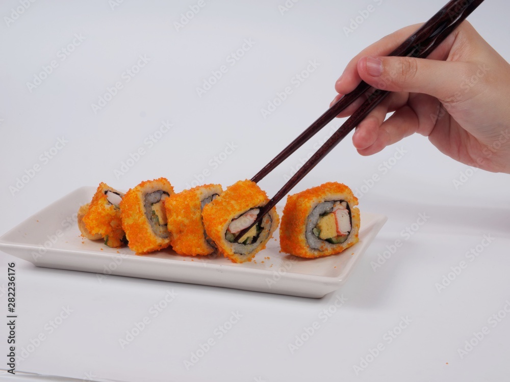 Wall mural sushi with chopsticks on white plate