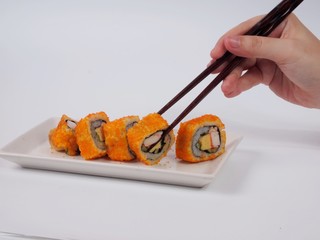 sushi with chopsticks on white plate