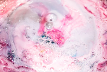 The bright bath bomb dissolves in water .