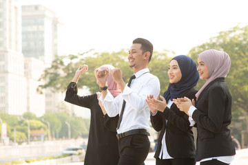 Muslim business people cheering